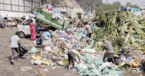 Bizarre…! People wander near Garbage Bins in search of black money