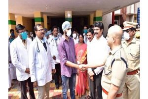 Andhra officials shake hands with man recovered from coronavirus